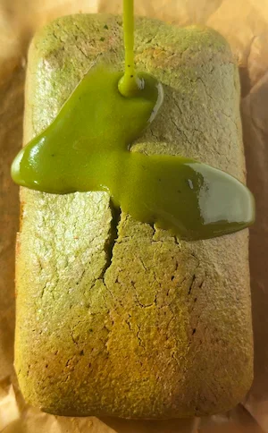 matcha icing drizzled on top of a healthy mini matcha loaf cake